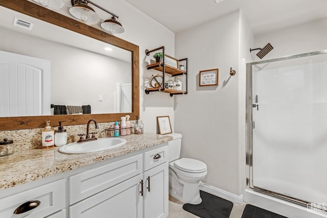 bathroom featuring vanity, toilet, tile patterned flooring, and a shower with door