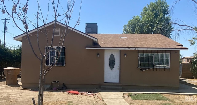 1231 6th St, Bakersfield, CA 93304 - bungalow featuring stucco siding, entry steps, roof with shingles, and a chimney