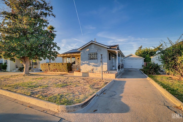 view of front of property with a garage and an outdoor structure