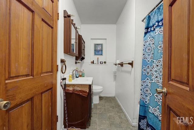 bathroom featuring toilet, vanity, crown molding, baseboards, and a shower with shower curtain