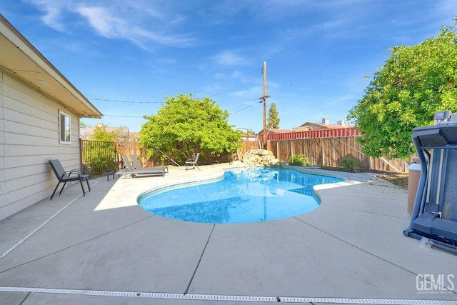 view of swimming pool with a fenced backyard, a patio area, and a fenced in pool