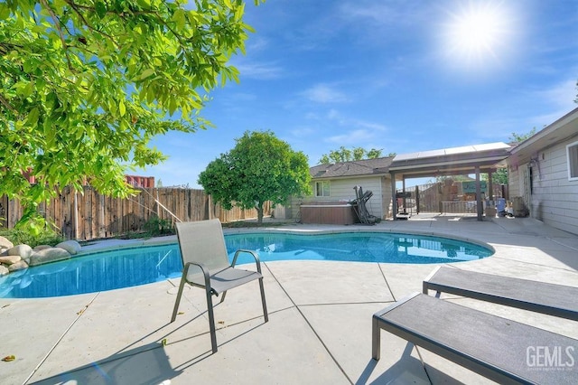 view of swimming pool featuring a patio area, a fenced in pool, a hot tub, and a fenced backyard