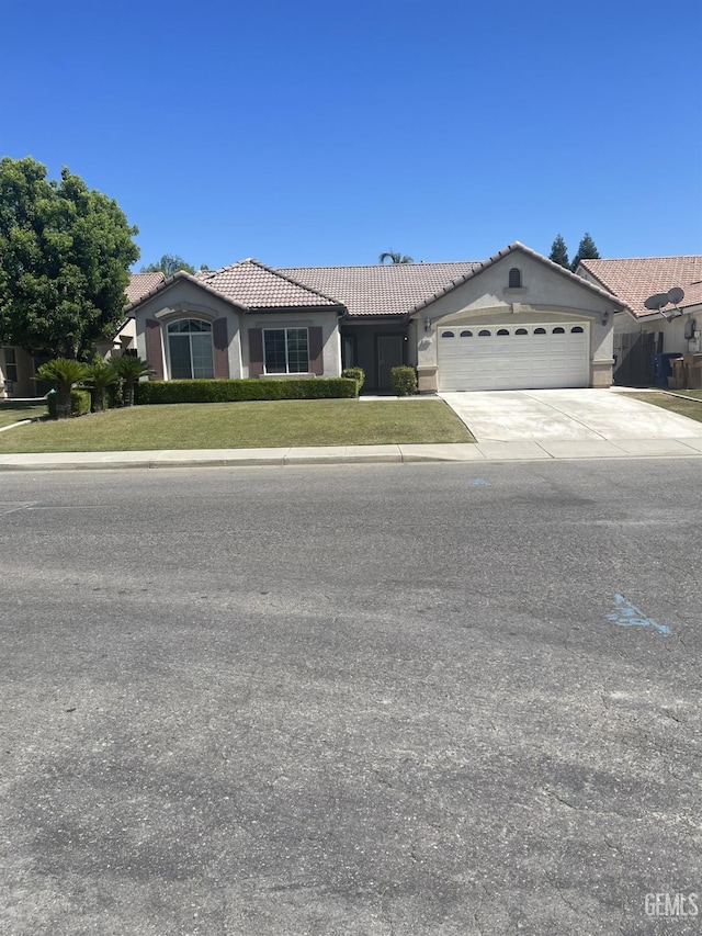 10931 Vista Del Valle Dr, Bakersfield, CA 93311 - view of front facade with a tiled roof, an attached garage, concrete driveway, and stucco siding