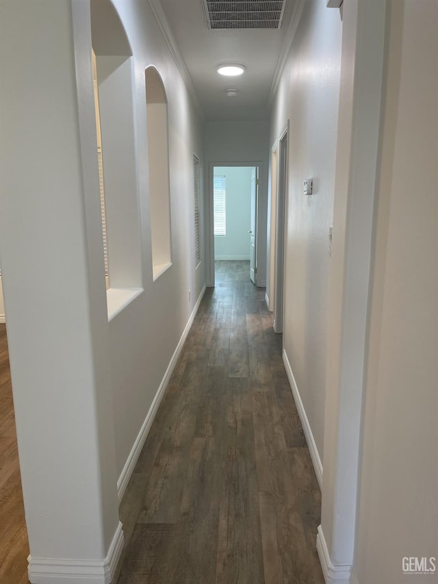 10931 Vista Del Valle Dr, Bakersfield, CA 93311 - hall with dark wood-style flooring, crown molding, and arched walkways