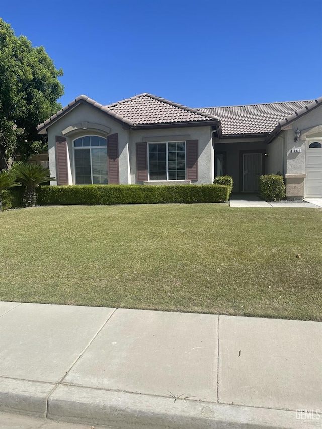 10931 Vista Del Valle Dr, Bakersfield, CA 93311 - ranch-style home with a tiled roof, an attached garage, a front lawn, and stucco siding