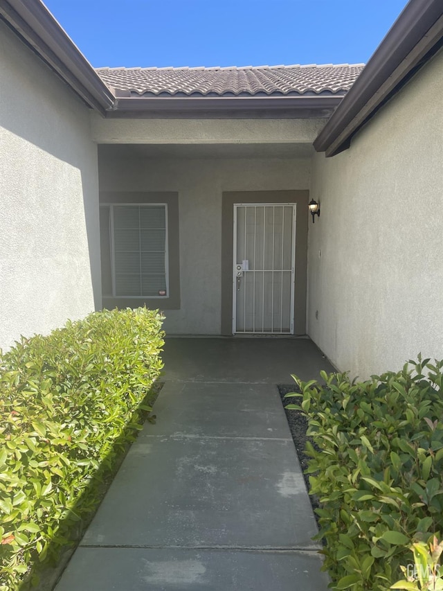 10931 Vista Del Valle Dr, Bakersfield, CA 93311 - view of exterior entry featuring stucco siding and a tile roof