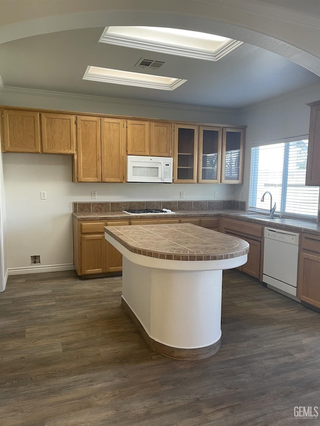 10931 Vista Del Valle Dr, Bakersfield, CA 93311 - kitchen with white appliances, tile counters, a center island, glass insert cabinets, and crown molding