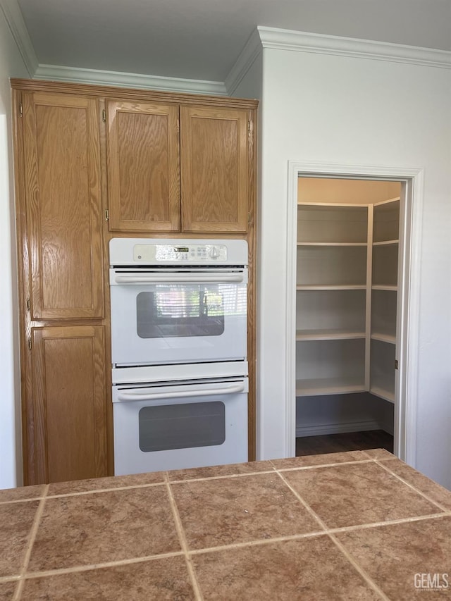10931 Vista Del Valle Dr, Bakersfield, CA 93311 - kitchen featuring white double oven, crown molding, and wood finished floors