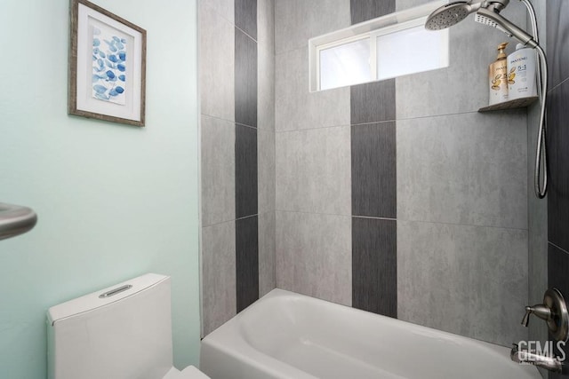 bathroom featuring washtub / shower combination and toilet