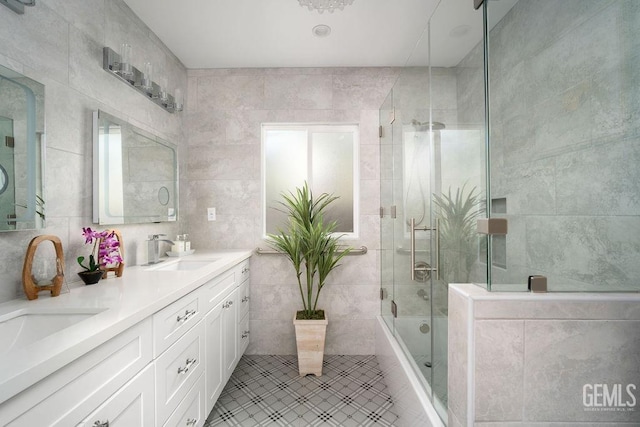 bathroom featuring vanity, tile patterned floors, and tile walls