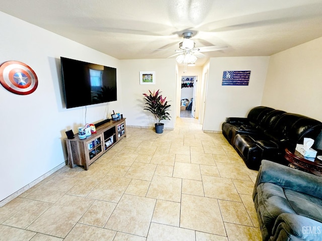 tiled living room with ceiling fan