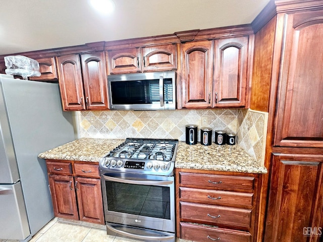 kitchen featuring light stone counters, light tile patterned floors, tasteful backsplash, and stainless steel appliances