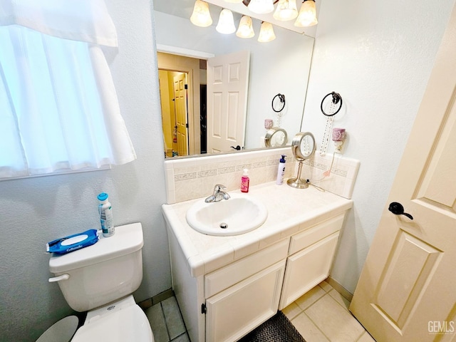 bathroom featuring tile patterned floors, toilet, and vanity