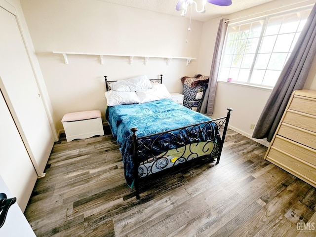 bedroom with hardwood / wood-style flooring and ceiling fan