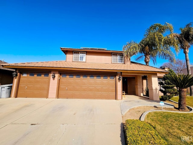 view of front of home with a garage and solar panels