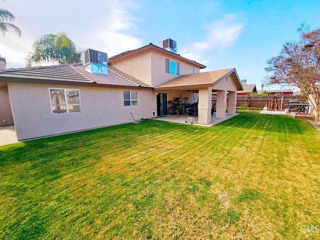 rear view of house featuring a patio and a lawn