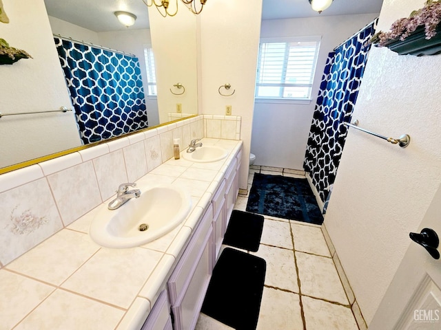 bathroom featuring tile patterned flooring, vanity, and toilet