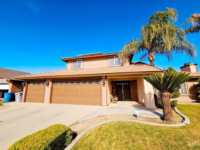 view of front facade featuring a garage and a front lawn