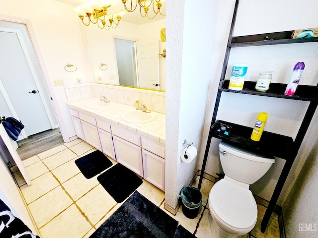 bathroom featuring vanity, tile patterned floors, and toilet