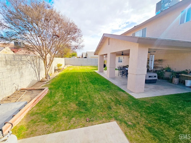 view of yard with a patio area and ceiling fan