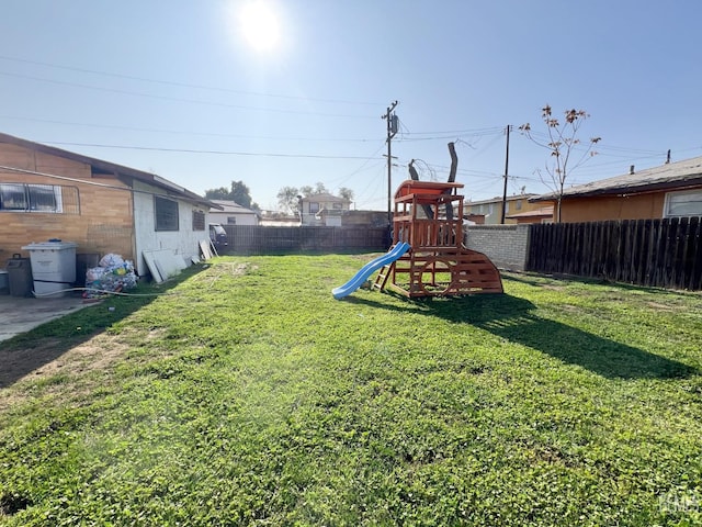 view of yard featuring a fenced backyard and a playground