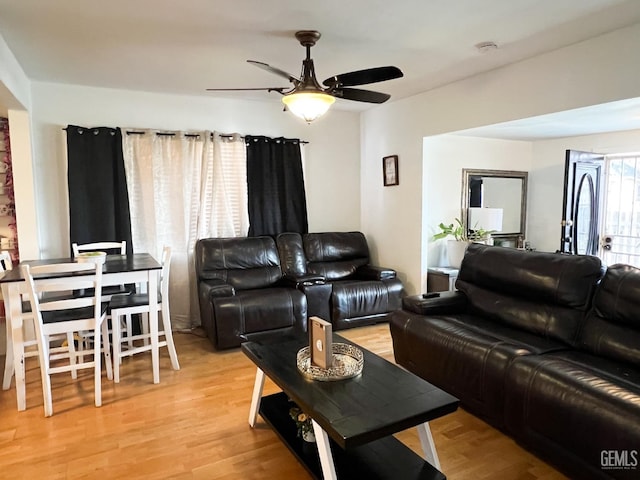 living area featuring a ceiling fan and wood finished floors