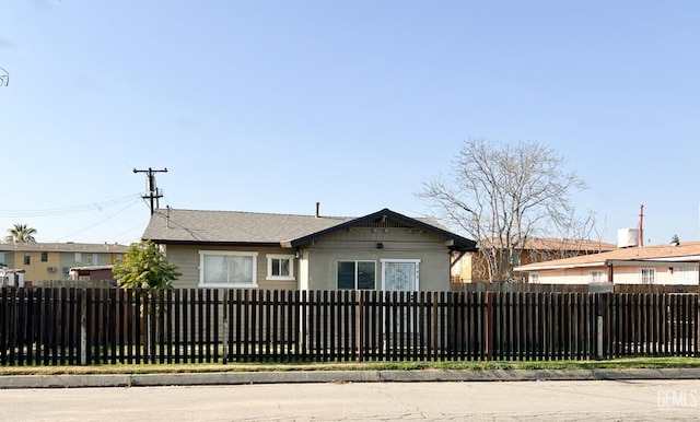 bungalow-style home featuring a fenced front yard