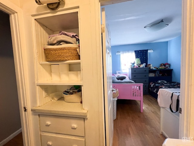 interior space with baseboards and wood finished floors