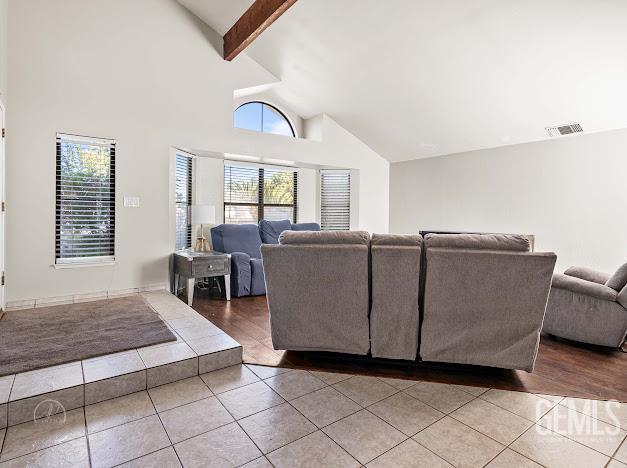 3717 Alcott Dr, Bakersfield, CA 93311 - living room with tile patterned floors, beam ceiling, and high vaulted ceiling