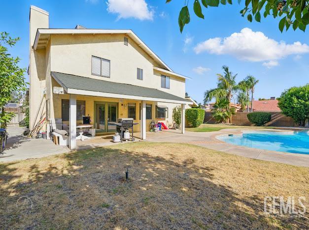 3717 Alcott Dr, Bakersfield, CA 93311 - rear view of house with a fenced backyard, a patio, french doors, and a chimney