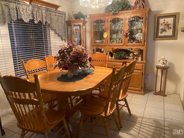 dining room featuring light tile patterned floors and an inviting chandelier