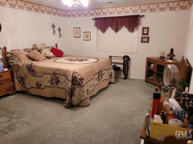 carpeted bedroom featuring visible vents and a ceiling fan