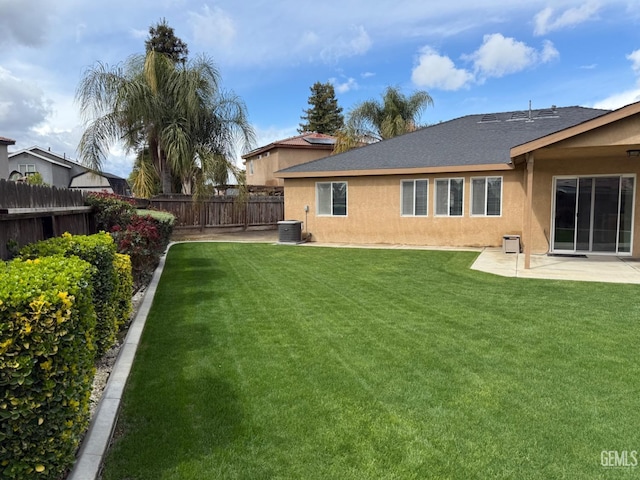 exterior space featuring stucco siding, a patio, a lawn, and a fenced backyard