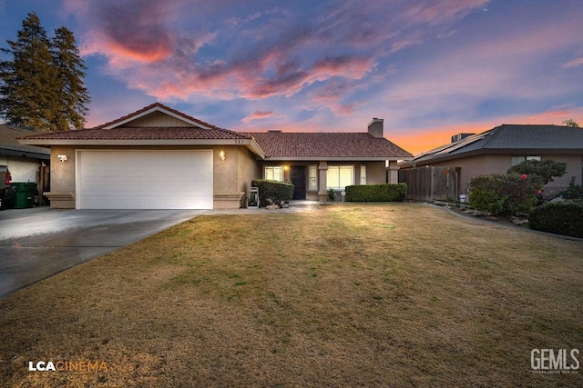 single story home with a yard and a garage