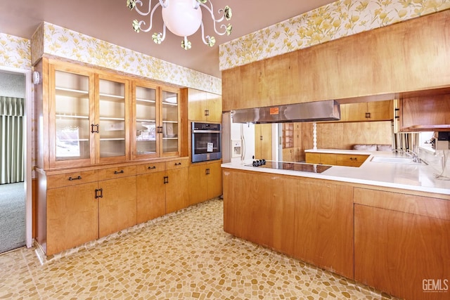 1830 Chevy Chase Way, Bakersfield, CA 93306 - kitchen with wallpapered walls, black electric cooktop, stainless steel oven, under cabinet range hood, and glass insert cabinets