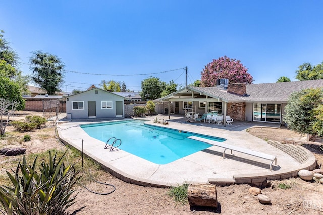 1830 Chevy Chase Way, Bakersfield, CA 93306 - view of swimming pool featuring a patio area, a fenced backyard, an outdoor structure, and a diving board
