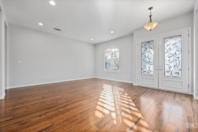 entrance foyer with recessed lighting, french doors, baseboards, and hardwood / wood-style floors