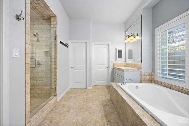 full bathroom with a stall shower, vanity, a bath, baseboards, and tile patterned floors