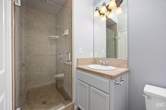 full bath with toilet, a stall shower, and backsplash