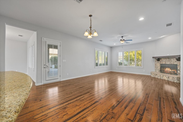 unfurnished living room with baseboards, a fireplace, visible vents, and hardwood / wood-style floors