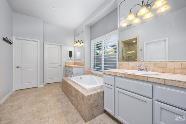 full bath featuring a garden tub, two vanities, a sink, tile patterned flooring, and tiled shower