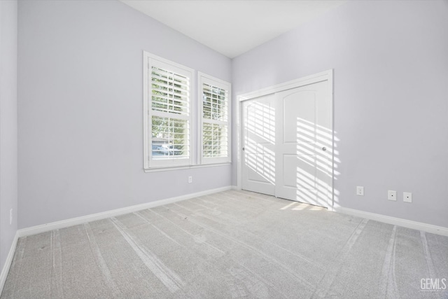 spare room with carpet floors and baseboards