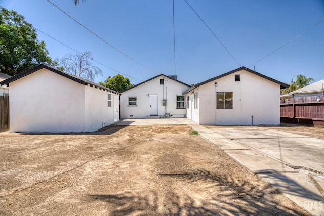 702 Wilson Ave, Bakersfield, CA 93308 - back of house featuring a patio and stucco siding