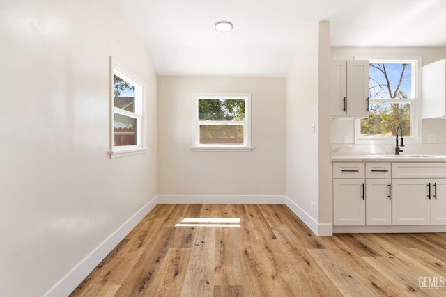 702 Wilson Ave, Bakersfield, CA 93308 - unfurnished dining area featuring light wood-style floors and baseboards