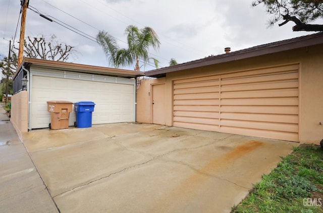 garage with concrete driveway