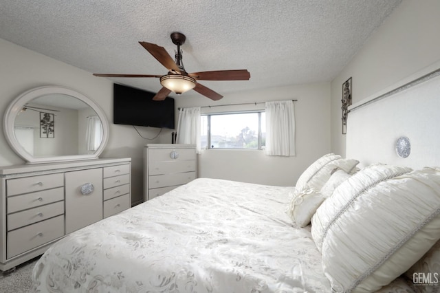 bedroom featuring a textured ceiling and a ceiling fan