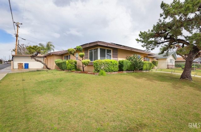 ranch-style home with a front lawn and stucco siding