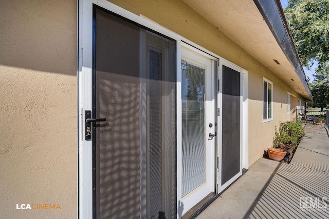 property entrance with a patio area