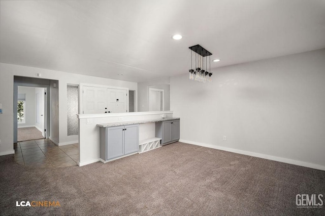 unfurnished living room with dark colored carpet