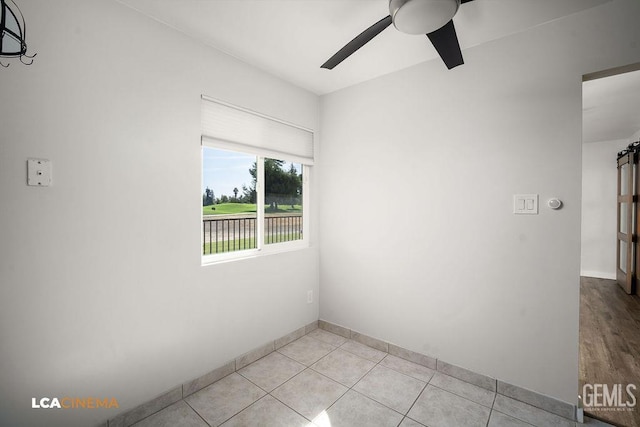 spare room with ceiling fan and light tile patterned flooring